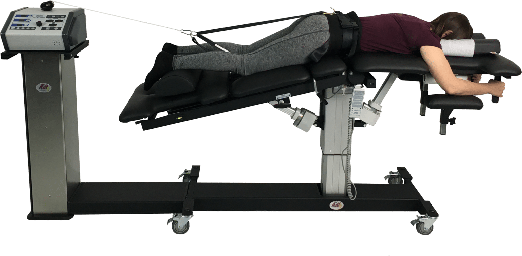 Patient receiving spinal decompression therapy on a treatment table