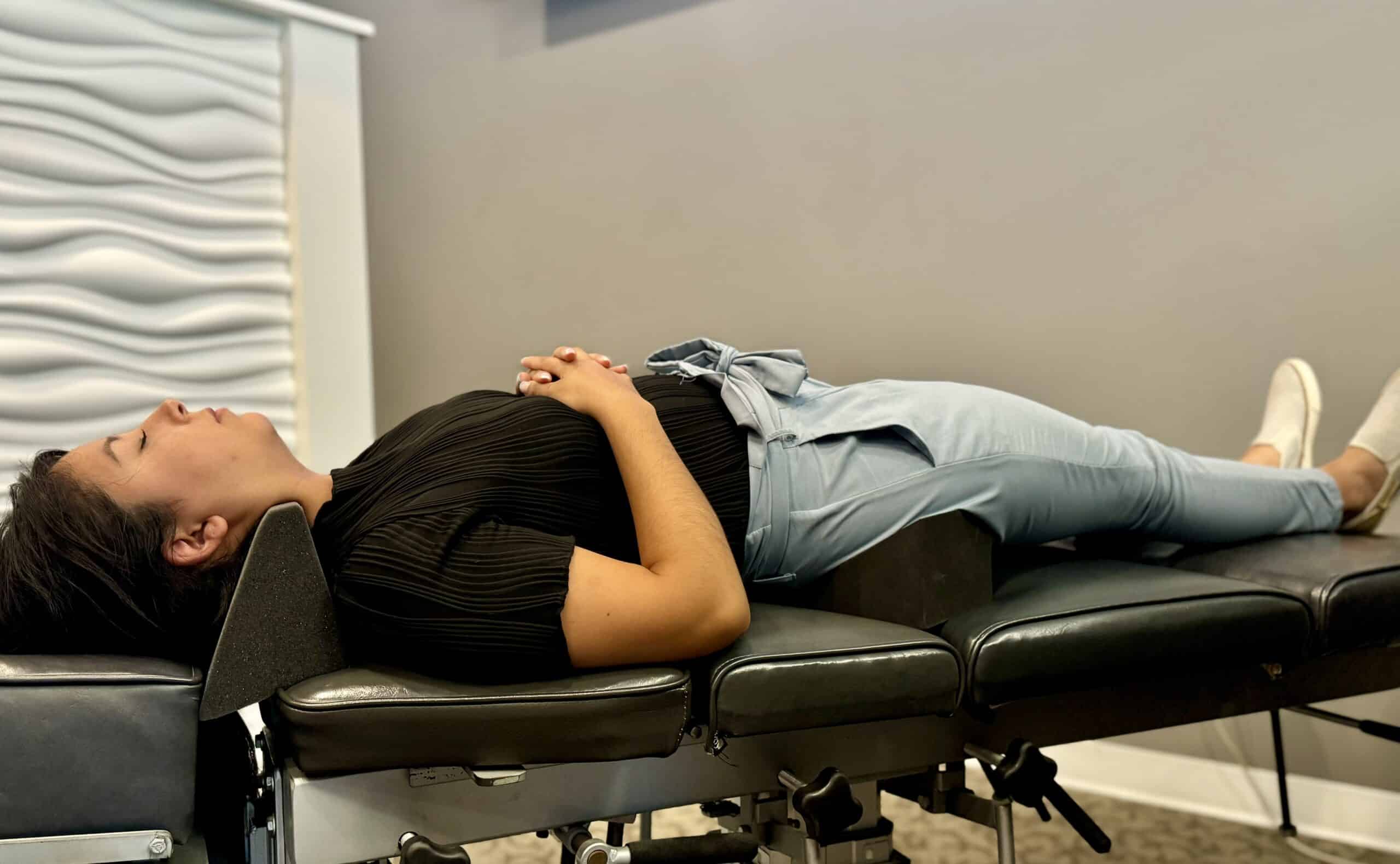 Patient using spinal molding equipment at Life Source Chiropractic in Omaha