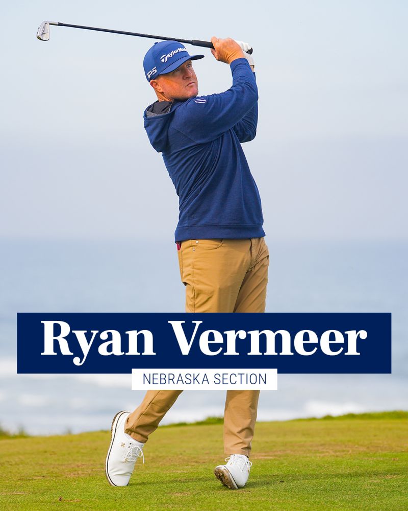 Ryan Vermeer following through on a golf swing in a blue pullover and cap
