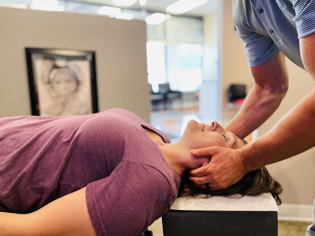 Dr. Jason Wiese providing hands-on chiropractic care at Life Source Chiropractic in Omaha