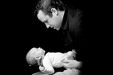 Dr. Jason Wiese holding an infant during a pediatric chiropractic visit